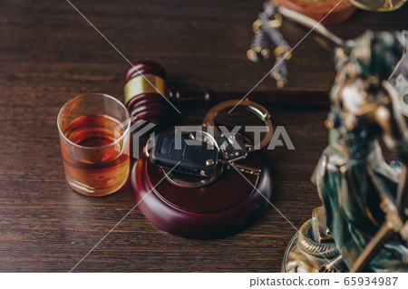 Whiskey with car keys and handcuffs. Concept for drinking and driving Whiskey with car keys and handcuffs. Concept for drinking and driving 65934987