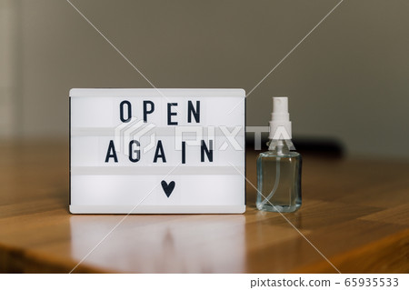 open again sigh on wooden table. local business reopen after quarantine covid-19 65935533