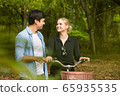 Happy young couple going for a bike ride on a 65935535