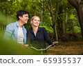 Young couple in love on bikes in the park 65935537