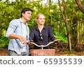 Young couple in love on bikes in the park 65935539