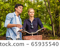 Young couple in love and going for a bike ride on 65935540
