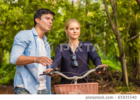 Young couple in love and going for a bike ride on Young couple in love and going for a bike ride on 65935540