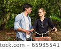 Happy young couple going for a bike ride on a 65935541