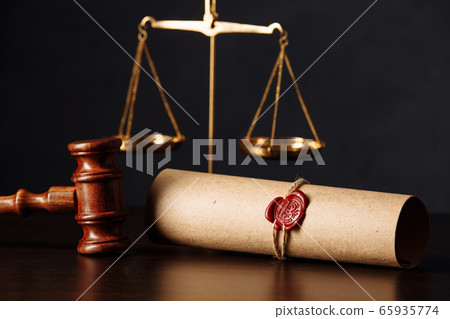Wooden gavel and scales near testament and last will. Notary public tools close-up 65935774