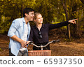 Romantic young couple in love and going for a bike 65937350
