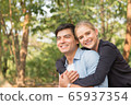 Romantic couple relaxing in the green park 65937354