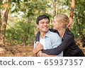 Beautiful loving couple flirting in the park 65937357