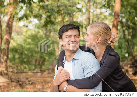 Beautiful loving couple flirting in the park 65937357