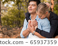 young happy couple relax in the park 65937359