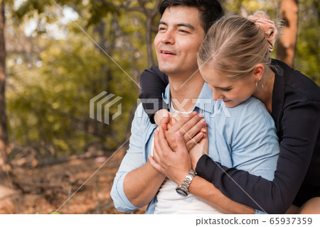 young happy couple relax in the park young happy couple relax in the park 65937359