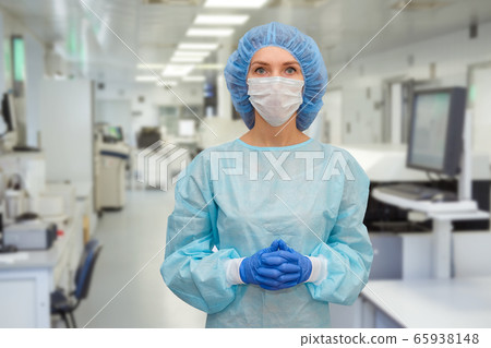 Portrait of doctor in scrubs. A female doctor in a protective face mask in safety measures against the coronavirus. 65938148