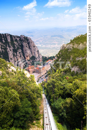 Montserrat monastery. Santa Maria de Montserrat is Benedictine abbey located on mountain of Montserrat, Monistrol de Montserrat, Catalonia, Spain Montserrat monastery. Santa Maria de Montserrat is Benedictine abbey located on mountain of Montserrat, Monistrol de Montserrat, Catalonia, Spain 65940249
