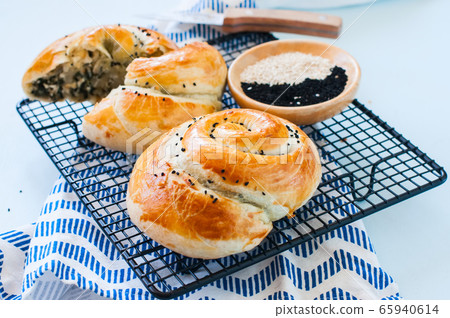 Freshly baked pie with spinach and cheese. Freshly baked pie with spinach and cheese. 65940614