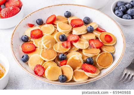Tiny pancakes with strawberries and blueberries Tiny pancakes with strawberries and blueberries 65940988