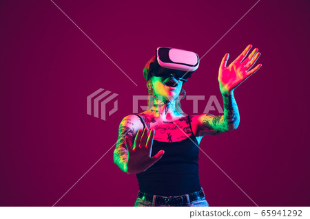 Portrait of young caucasian woman on purple background with copyspace, unusual and freaky appearance 65941292