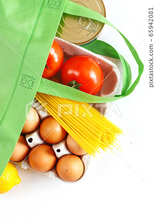 Full green bag of healthy food on a white background. Top view. fruit, vegetable, eggs online shop. your text. food delivery 65942081