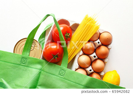 Full green bag of healthy food on a white background. Top view. fruit, vegetable, eggs online shop. your text. food delivery Full green bag of healthy food on a white background. Top view. fruit, vegetable, eggs online shop. your text. food delivery 65942082