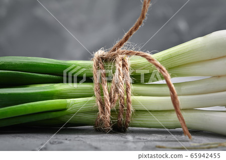 Chives, food and health concept, with space for text on a gray background. Natural fresh product rich in trace elements. Close-up Chives, food and health concept, with space for text on a gray background. Natural fresh product rich in trace elements. Close-up 65942455