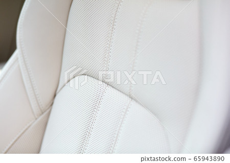 White leather seat of an expensive and luxurious car. Shallow depth of field. White leather seat of an expensive and luxurious car. Shallow depth of field. 65943890