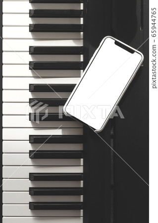 Isolated smartphone screen on piano. 65944765