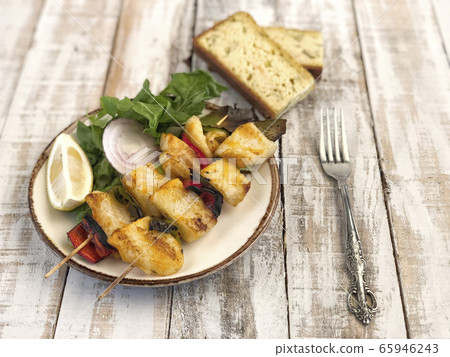 Skewed sole fish served with salad and corn bread 65946243