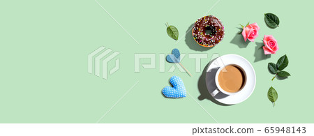 A cup of coffee with pink roses 65948143