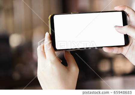 mock-up phone in hand holding on blur restaurant mock-up phone in hand holding on blur restaurant 65948683