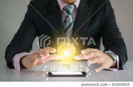 Light bulb new ideas with innovative technology solution concepts hands of the businessman. 65949005
