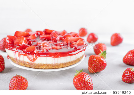 cheesecake with strawberry and fresh berries on gray table and white background 65949240