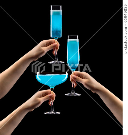 Set of hands holding glass of blue sparkling Set of hands holding glass of blue sparkling 65949859