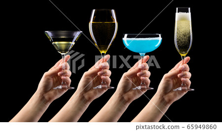 Set of hands holding cocktails isolated on black 65949860
