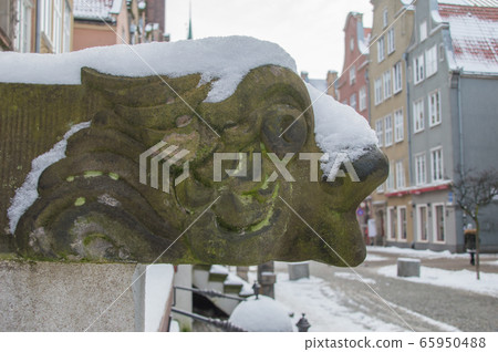 Historical handrail with dragon covered by swnow in old town of Gdansk in Poland. 65950488