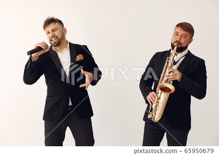 Two adult musicians standing in studio Two adult musicians standing in studio 65950679