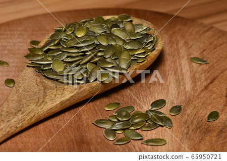 Pumpkin seeds in a pile wide angle macro sliding 65950721