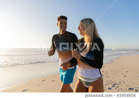 Caucasian couple enjoying time at the beach Caucasian couple enjoying time at the beach 65958656