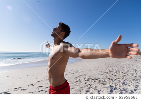 Caucasian man enjoying time at the beach 65958663