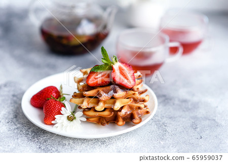 Delicious fresh baked belgian waffles with berries Delicious fresh baked belgian waffles with berries 65959037