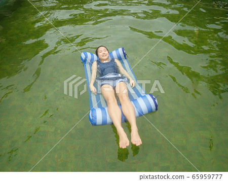 Girl playing in hot spring 65959777
