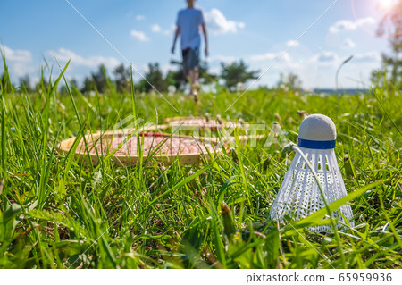 a badminton shuttlecock is lying on the playing lawn a badminton shuttlecock is lying on the playing lawn 65959936