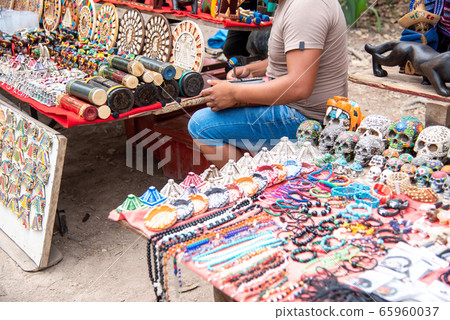 A person selling souvenirs next to the ruins of Chichen Itza, Mexico 65960037