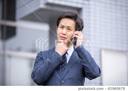 打電話給智能手機時遇到麻煩的商人（麻煩） 65960679