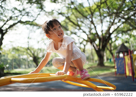 Asian chinese girl managing playground obstacle on Asian chinese girl managing playground obstacle on 65962222