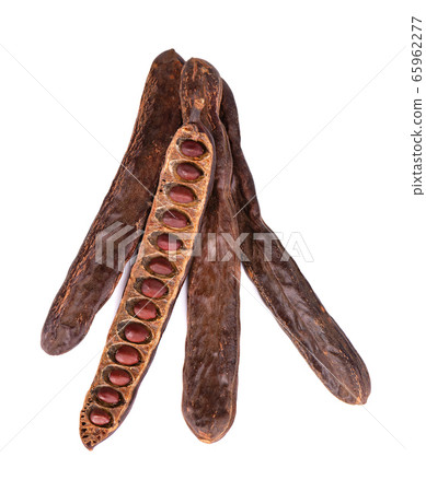 Ripe carob pods and bean isolated on white 65962277