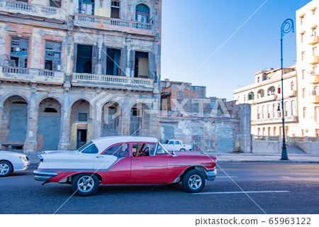 Classic car running on Malecon Street in Cuba Havana Classic car running on Malecon Street in Cuba Havana 65963122