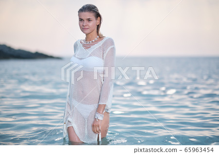 fit woman in posing on beach. Stylish look woman fit woman in posing on beach. Stylish look woman 65963454