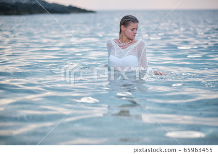 fit woman in posing on beach. Stylish look woman fit woman in posing on beach. Stylish look woman 65963455