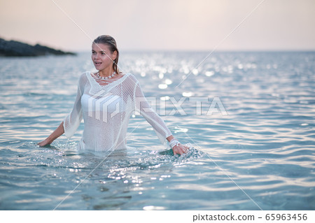 fit woman in posing on beach. Stylish look woman fit woman in posing on beach. Stylish look woman 65963456