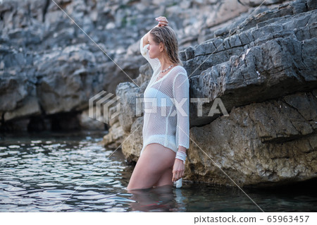 fit woman in posing on beach. Stylish look woman fit woman in posing on beach. Stylish look woman 65963457