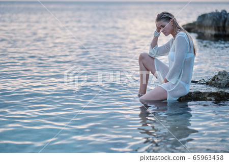 fit woman in posing on beach. Stylish look woman fit woman in posing on beach. Stylish look woman 65963458